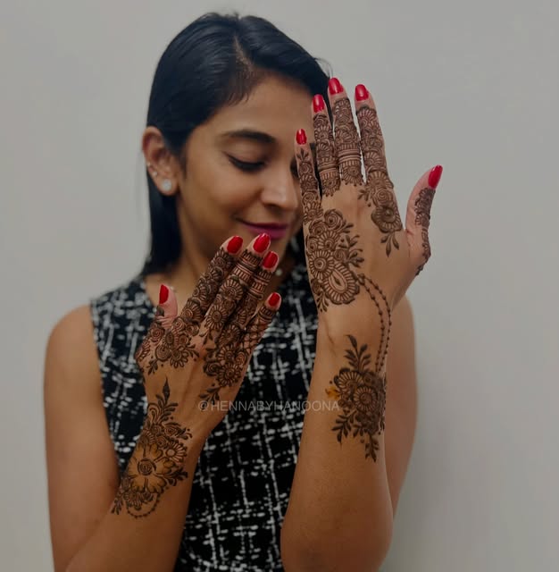 Party henna across both hands and one forearm